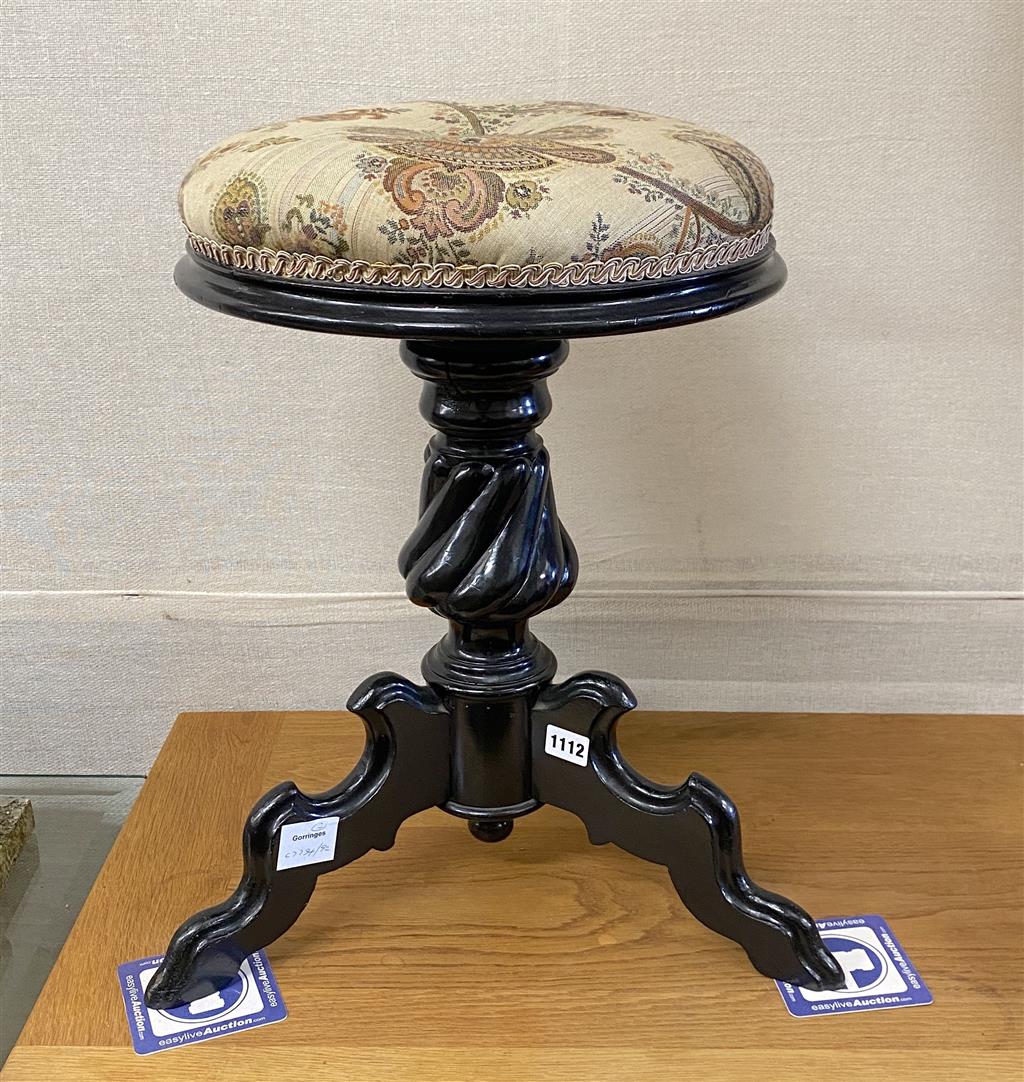 A 19th century French ebonised revolving adjustable piano stool